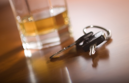 A drink sitting next to a pair of keys - have you been charged with a holiday DUI? Contact Branson West Law today!